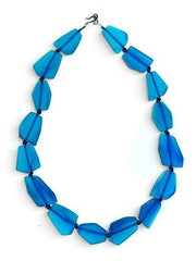 POLKA LUKA abstract necklace featuring translucent blue geometric resin beads on a dark cord