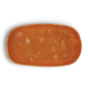 POLKA LUKA Cezanne rectangular resin serving bowl in a marbled burnt orange finish with a smooth, organic shape.