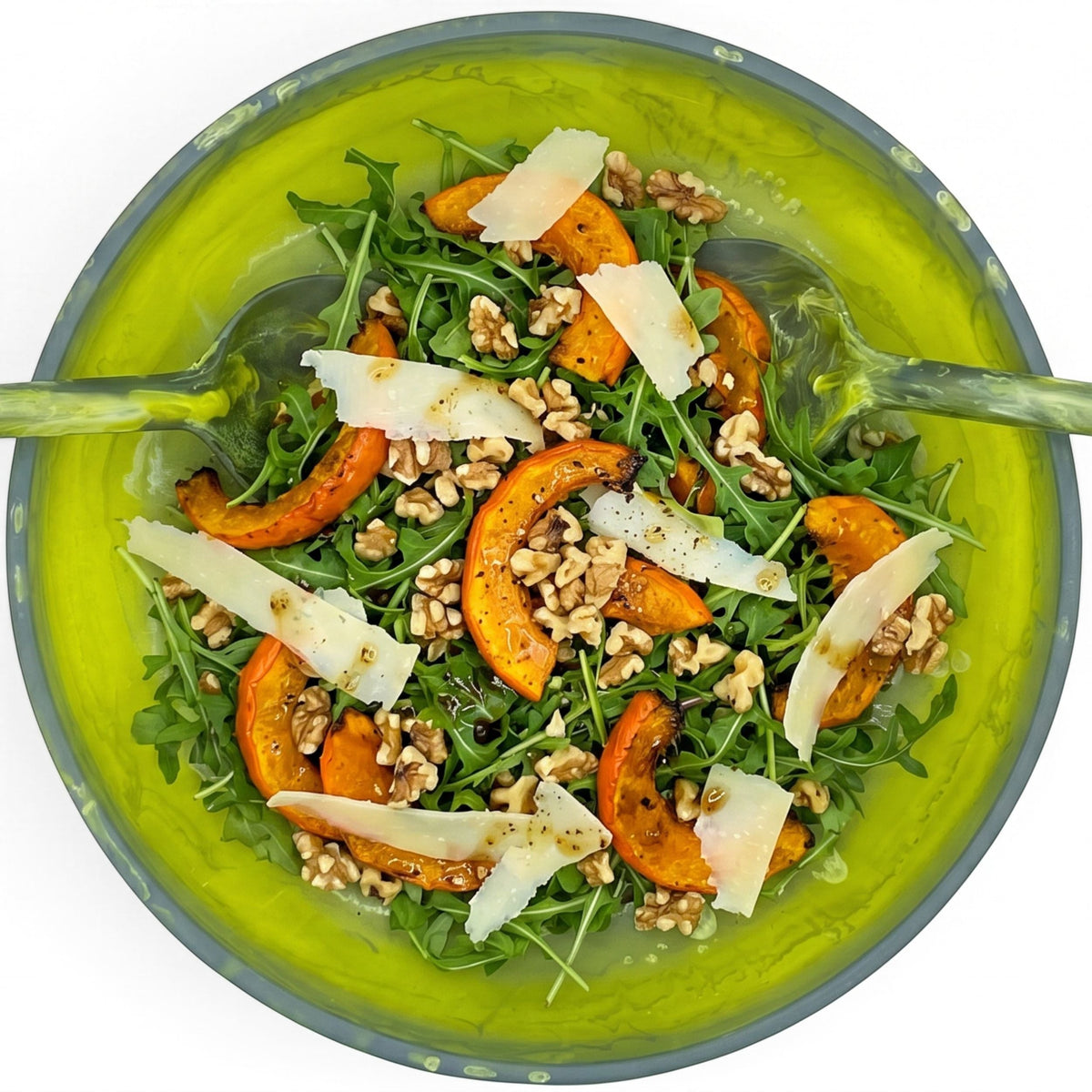 POLKA LUKA medium lime green resin salad bowl filled with roasted pumpkin, arugula, walnuts, and parmesan shavings.