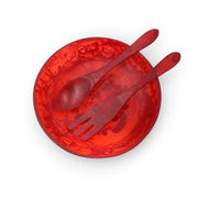 POLKA LUKA large red resin salad bowl with matching long salad servers in a marbled design, top-down view.
