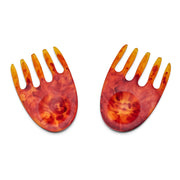 POLKA LUKA resin salad hands in a vibrant marbled orange and red finish with a unique hand-shaped design.