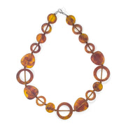 POLKA LUKA Tangier necklace featuring amber-toned resin geometric beads on a cotton cord, 54cm length.