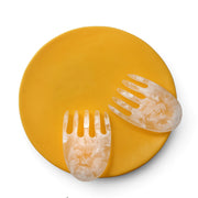 POLKA LUKA large yellow resin Luna serving plate with translucent white marbled salad hands on a white background